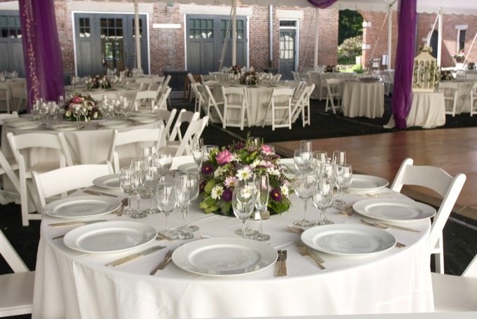 Event venue with crisp white tablecloths and formal place settings — linen rental service by Valley Laundry