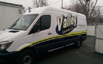 Valley Laundry delivery van with company branding used for scheduled pick-up and delivery routes across southwest Ohio